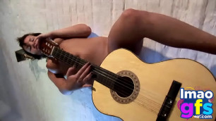 Hot Paul showing her medium tits and pussy with guitar